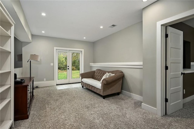 living area featuring french doors and carpet floors