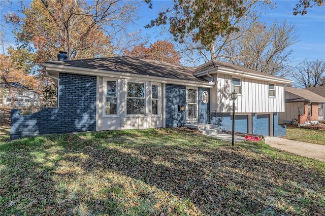 tri-level home with a garage and a front lawn