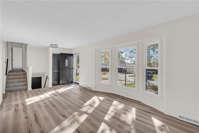 unfurnished living room with hardwood / wood-style floors