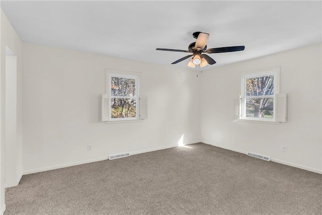 empty room with ceiling fan and carpet floors