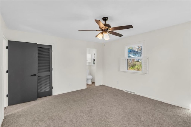 unfurnished room featuring light carpet and ceiling fan