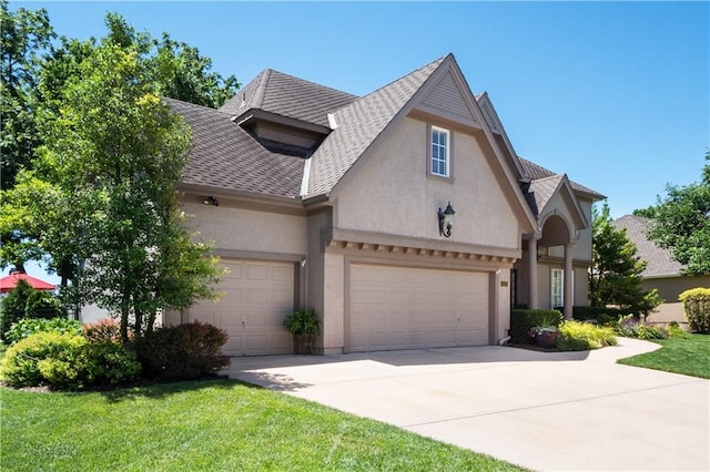 view of front of house with a garage and a front yard