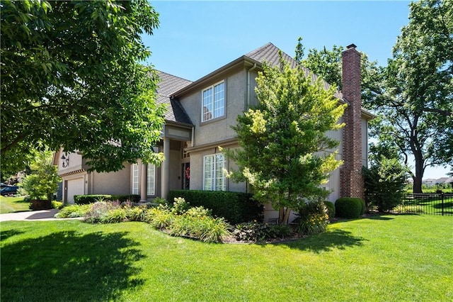 view of front of property with a garage and a front lawn