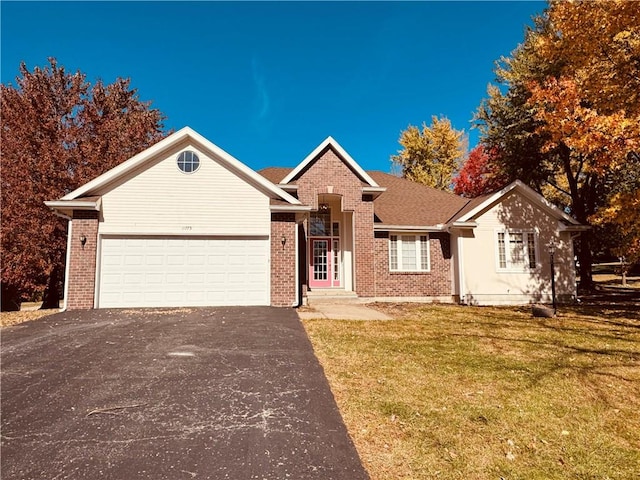 ranch-style home with a garage and a front lawn