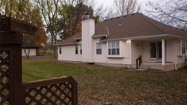 back of house featuring a yard