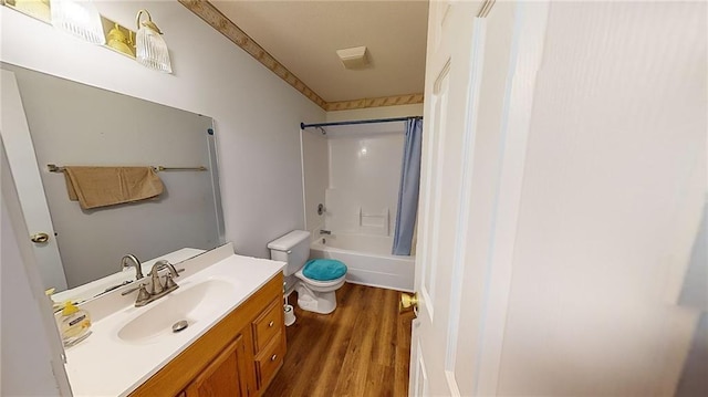 full bathroom with hardwood / wood-style floors, vanity, toilet, and shower / bath combo with shower curtain