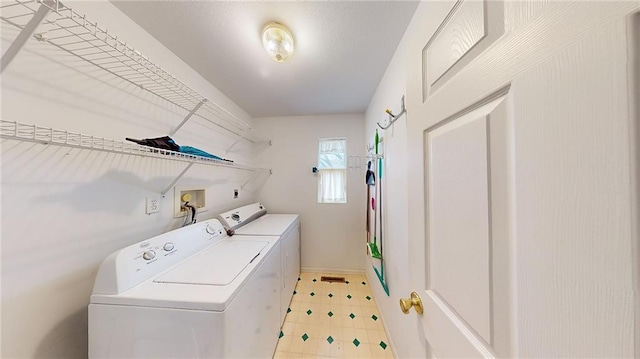 washroom with washing machine and clothes dryer