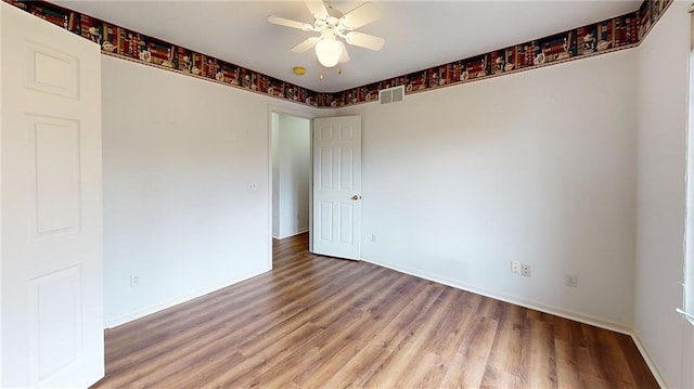 unfurnished room with ceiling fan and wood-type flooring