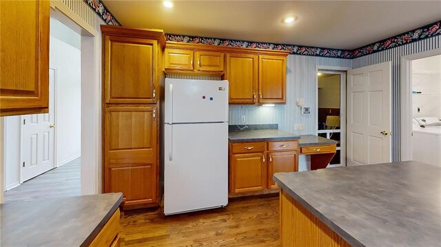 kitchen featuring wood-type flooring, white fridge, and tasteful backsplash