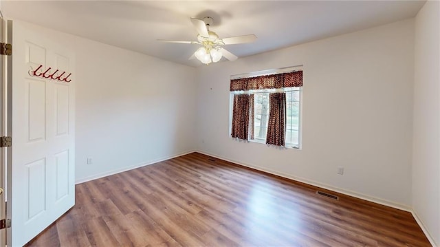 unfurnished room with hardwood / wood-style flooring and ceiling fan