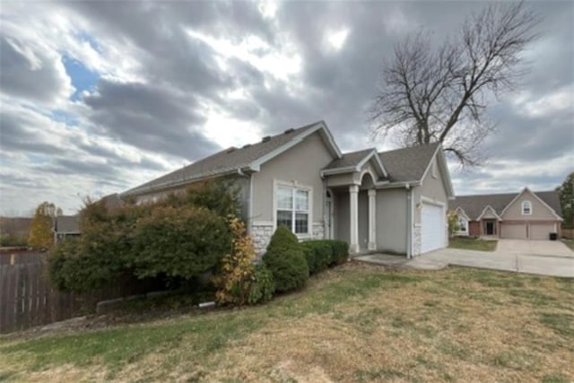 view of front of property with a garage and a front yard