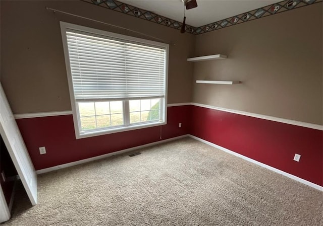 empty room with ceiling fan and carpet flooring