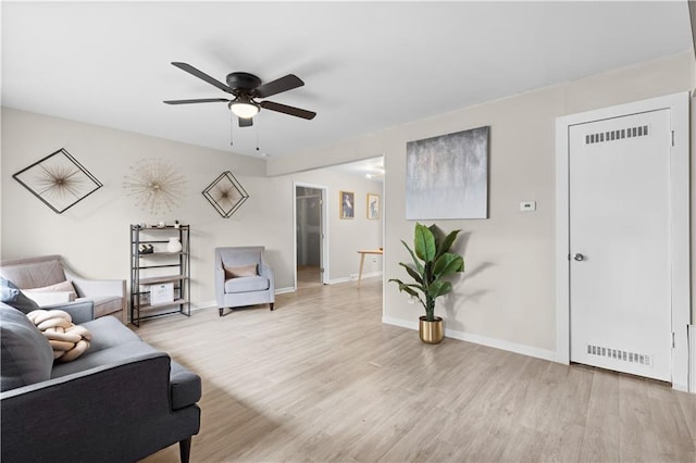 living room featuring ceiling fan and light hardwood / wood-style floors