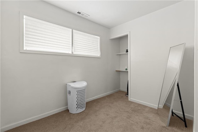 unfurnished bedroom featuring light colored carpet and multiple windows