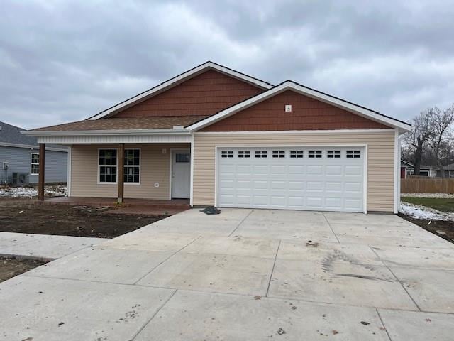 view of front of property with a porch and a garage