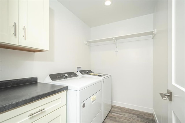 laundry room featuring separate washer and dryer, recessed lighting, light wood finished floors, baseboards, and cabinet space