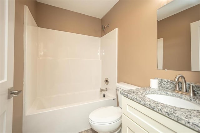 bathroom with toilet, vanity, and shower / tub combination