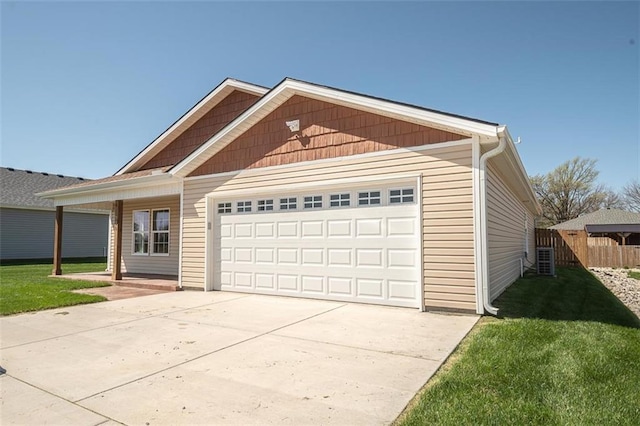 view of front facade with a front yard, an attached garage, concrete driveway, fence, and central air condition unit