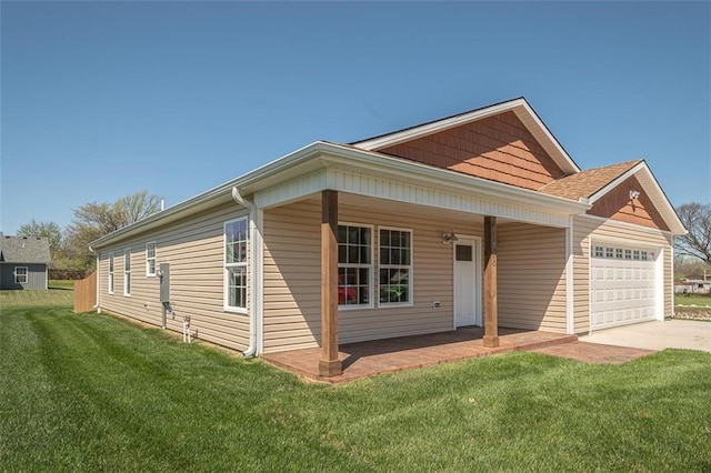 view of front of house with driveway, a front lawn, covered porch, and a garage