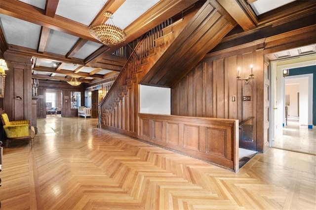 hallway featuring vaulted ceiling with beams, wooden walls, light parquet floors, and a chandelier