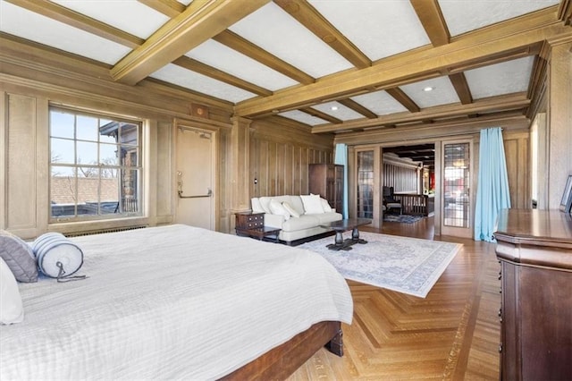 bedroom with beam ceiling, wood walls, and parquet floors