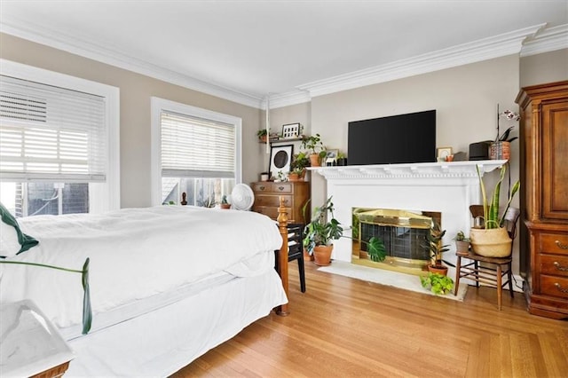 bedroom featuring light hardwood / wood-style floors and crown molding