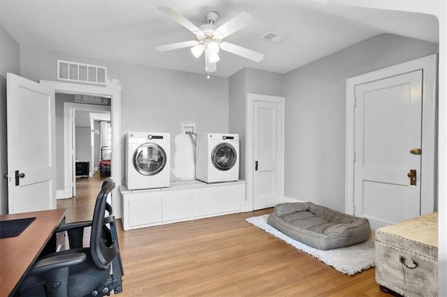 washroom with separate washer and dryer, ceiling fan, and light wood-type flooring