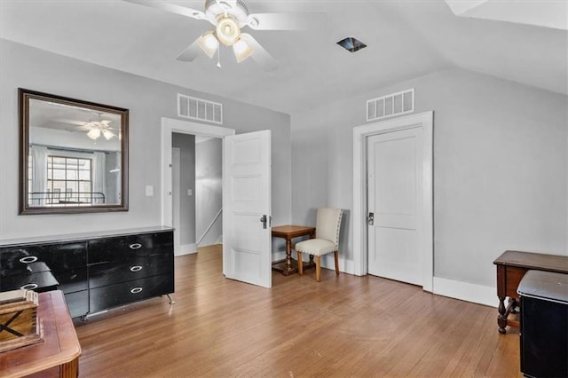 living area featuring ceiling fan, lofted ceiling, and light wood-type flooring