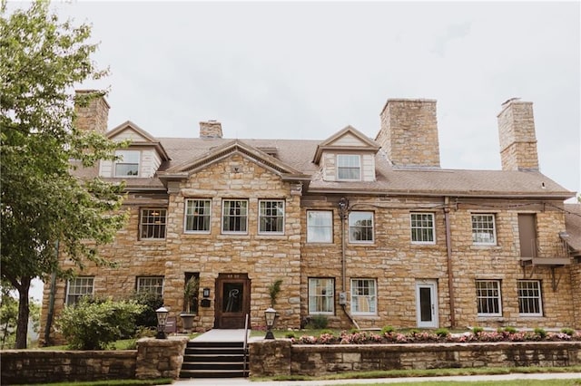 view of front facade with a chimney