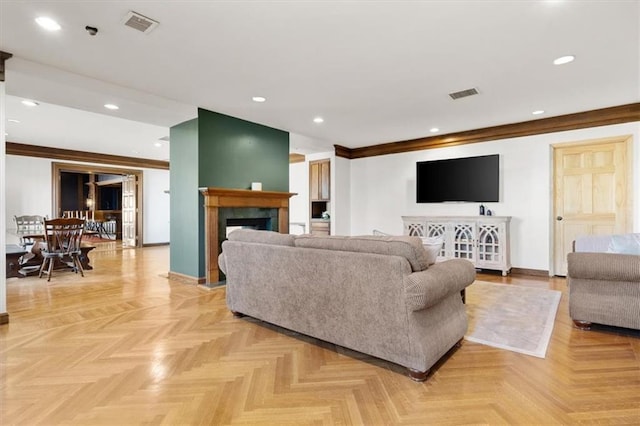 living area with baseboards, a high end fireplace, visible vents, and recessed lighting