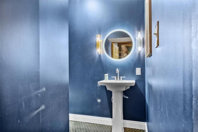 bathroom with a sink, tile patterned flooring, and baseboards