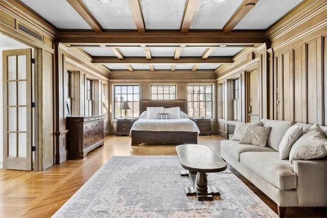 bedroom featuring visible vents, coffered ceiling, beamed ceiling, crown molding, and wood walls