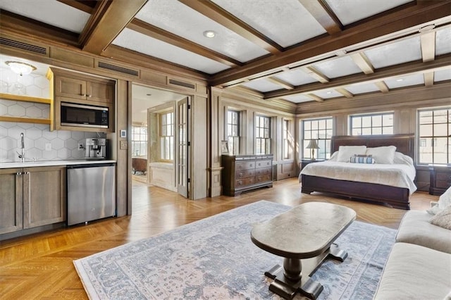 bedroom featuring coffered ceiling, visible vents, a sink, and beamed ceiling