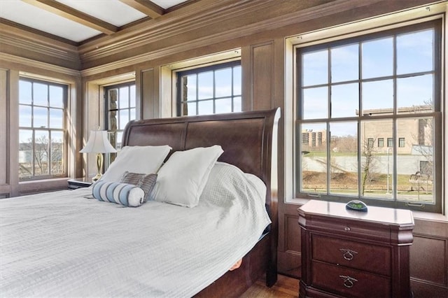 bedroom featuring beamed ceiling and crown molding