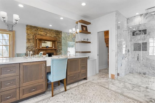 bathroom featuring recessed lighting, marble finish floor, vanity, and a marble finish shower