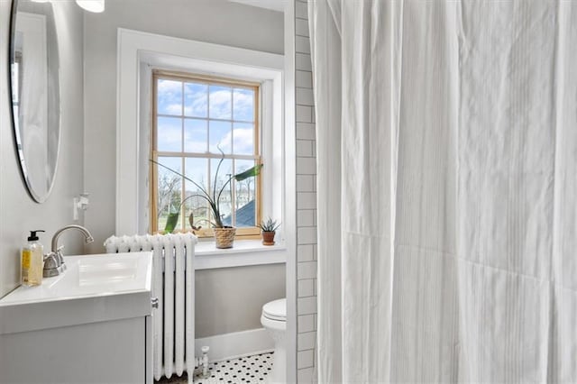 full bathroom with curtained shower, toilet, vanity, baseboards, and radiator heating unit