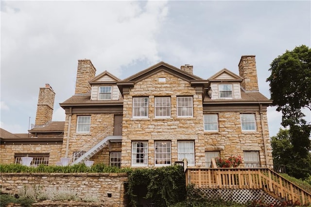 view of front of property with stairway and a chimney