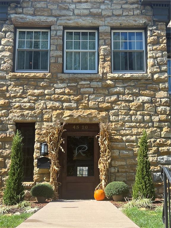 doorway to property featuring stone siding