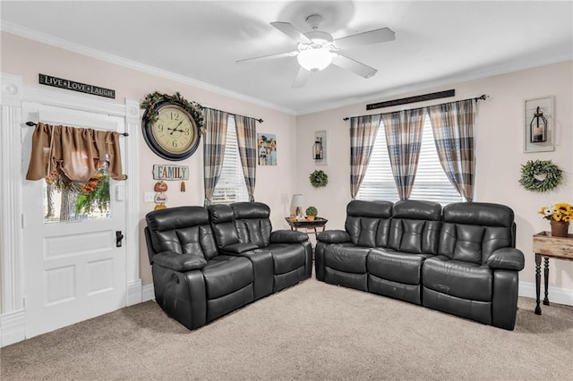 carpeted living area featuring a ceiling fan, ornamental molding, and baseboards