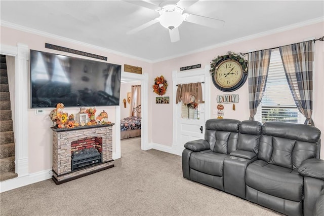 carpeted living room with a fireplace, ceiling fan, and ornamental molding