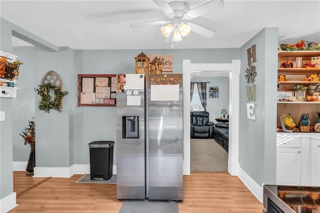 hallway with light wood finished floors and baseboards
