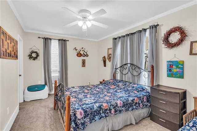 carpeted bedroom featuring ornamental molding, ceiling fan, and baseboards