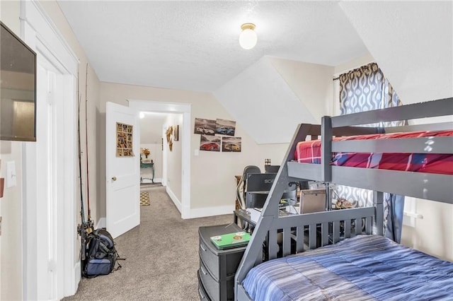 carpeted bedroom with a textured ceiling and baseboards