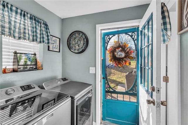 clothes washing area featuring independent washer and dryer