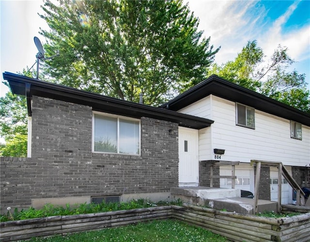 tri-level home featuring a patio area