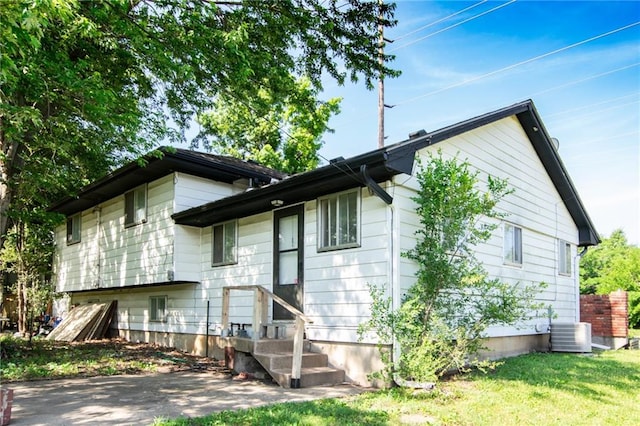 back of house featuring central air condition unit