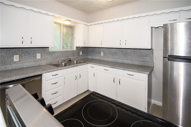 kitchen with white cabinets, sink, decorative backsplash, and appliances with stainless steel finishes