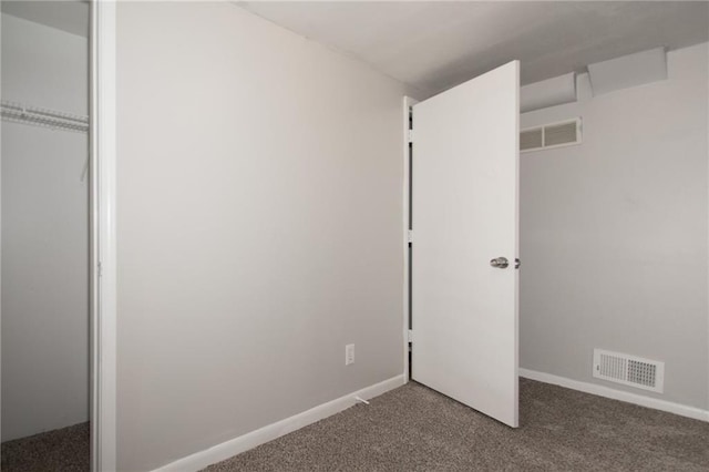 unfurnished bedroom with a closet and carpet