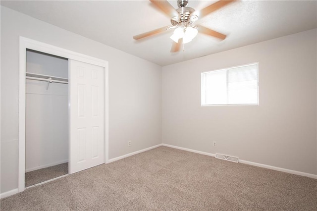 unfurnished bedroom featuring a closet, carpet flooring, and ceiling fan