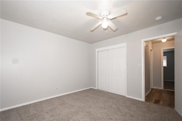 unfurnished bedroom with carpet floors, ceiling fan, and a closet